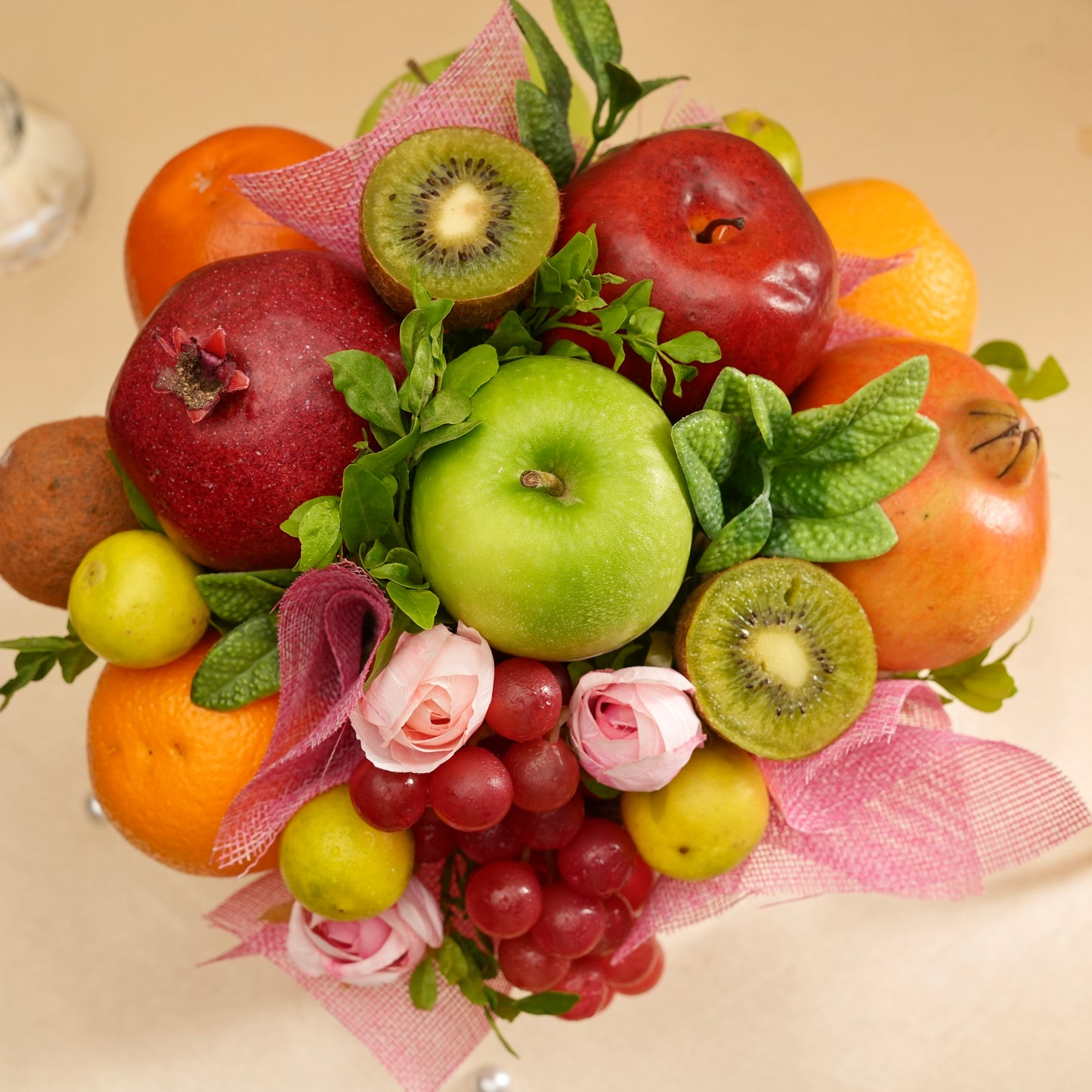Fruit and flower arrangement on a beige background
