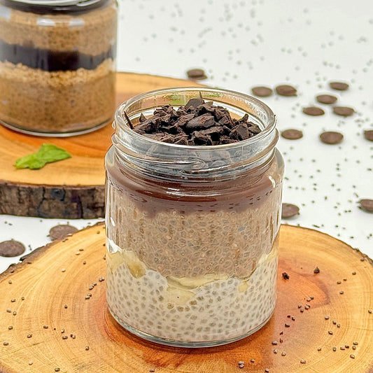 Glass jar with layered dessert on a wooden surface