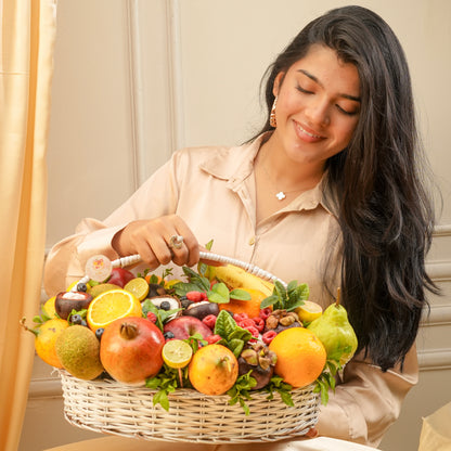Woman holding a basket of fruits and smiling