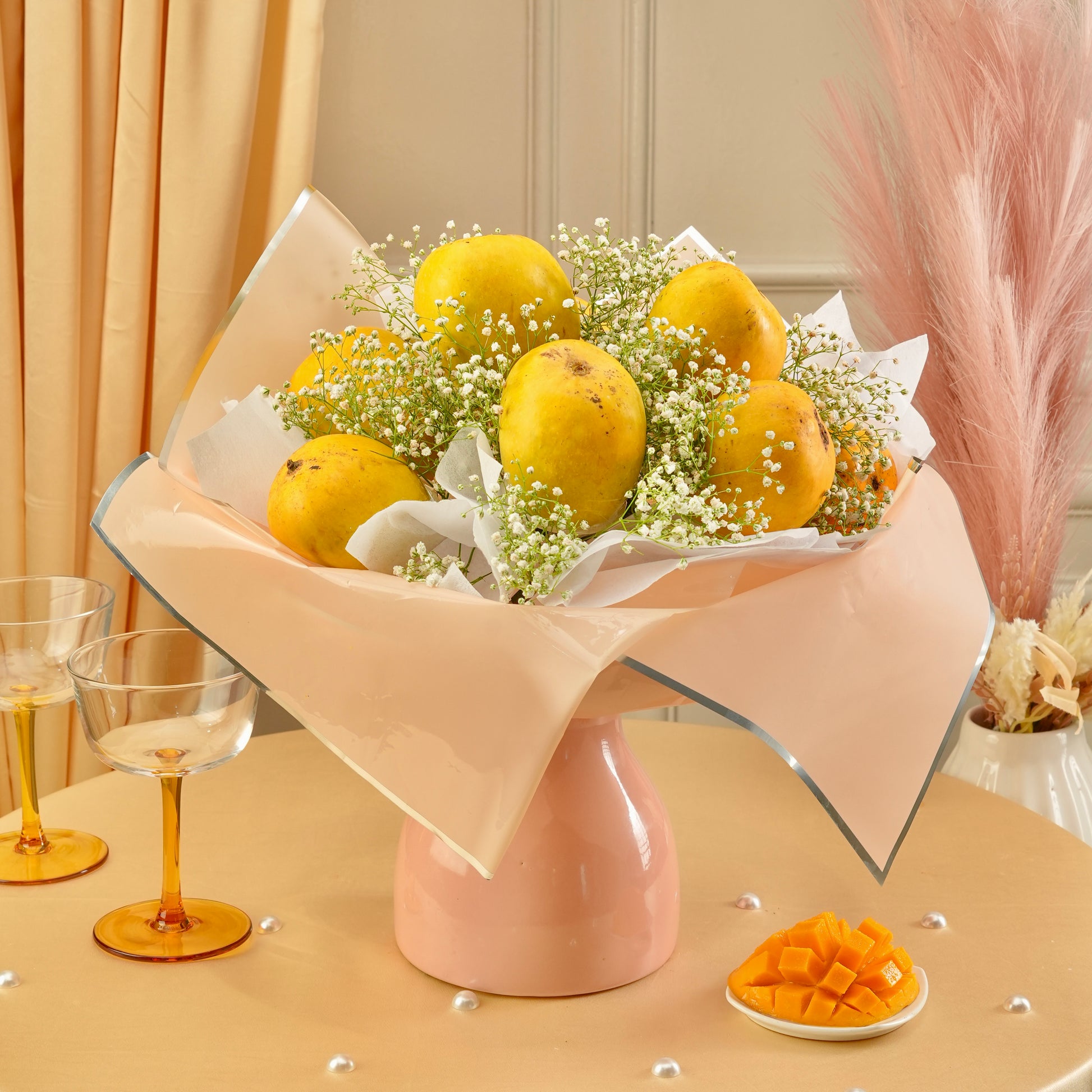 Mango Blossom luxury mango bouquet with fresh yellow mangoes and delicate white baby’s breath flowers in elegant pastel wrapping.