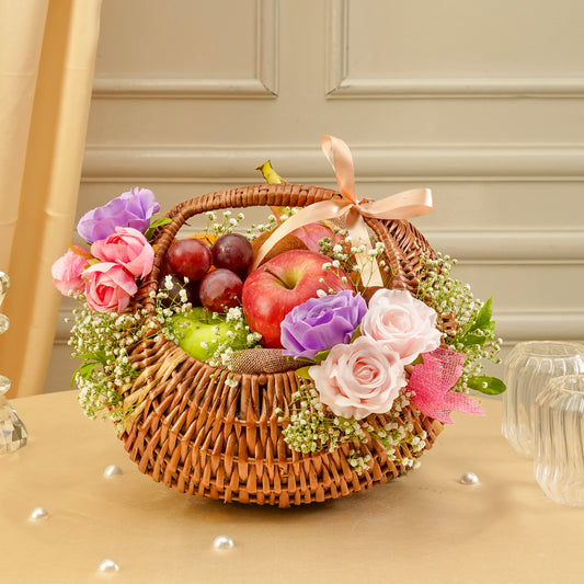 Decorative basket with fruits and flowers on a table