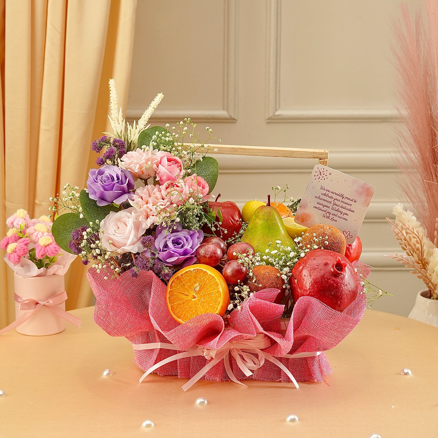 Bouquet of flowers and fruits on a table with decorative elements.