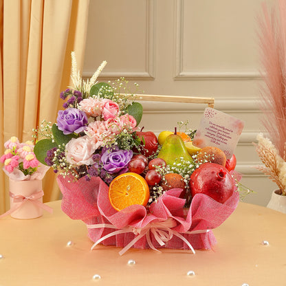 Bouquet of flowers and fruits on a table with decorative elements.