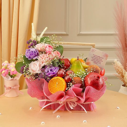 Bouquet of flowers and fruits on a table with decorative elements.